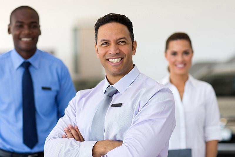 Two Men and Woman Sales People in Standing Position